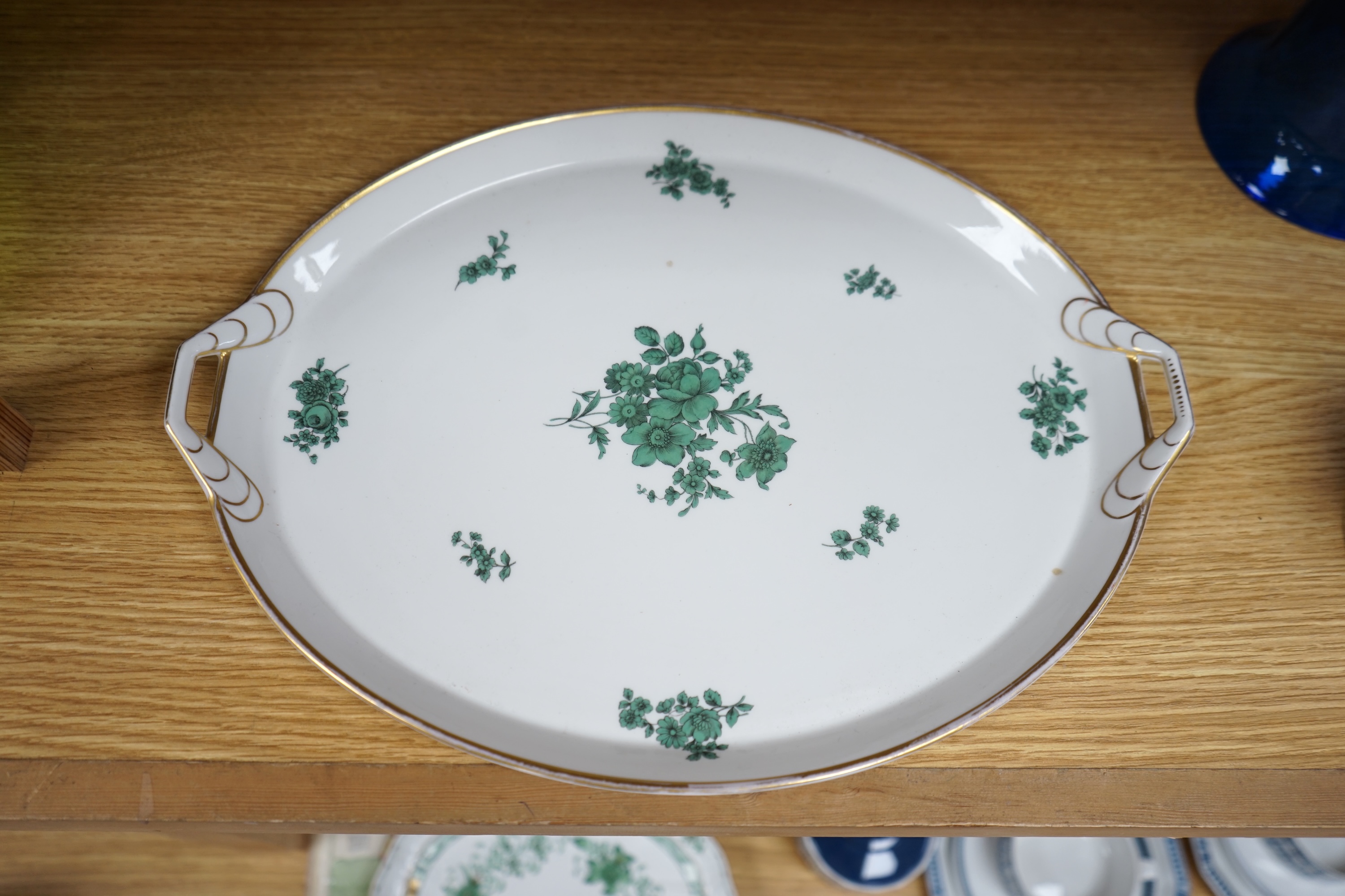 A Herend green decorated tray, 26cm wide, a similar pair of dishes and a basket, together with another larger porcelain tray, 39cm wide (5). Condition - good.